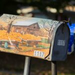 brown and white mail box on brown wooden fence during daytime